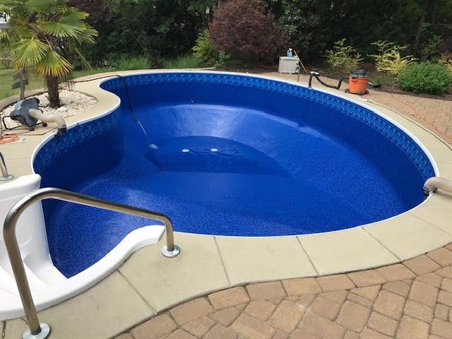 After: Oval pool &mdash; new liner with a decorative waterline band