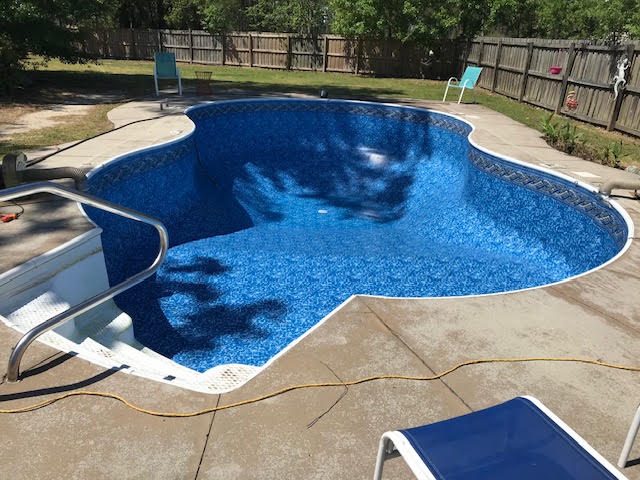 After: Freeform pool &mdash; new liner replacing a failed one
