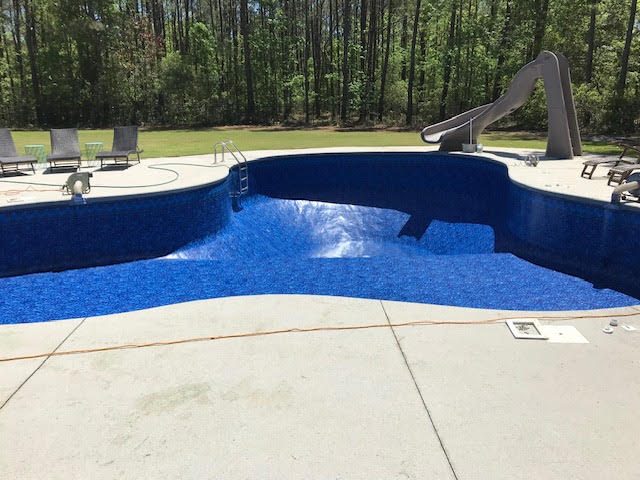 After: Large freeform pool with slide &mdash; new vinyl liner