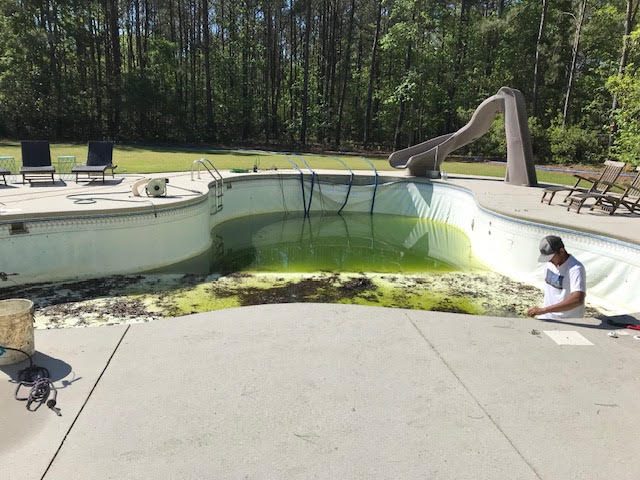 Before: worn or failed vinyl liner, Large freeform pool with slide &mdash; new vinyl liner