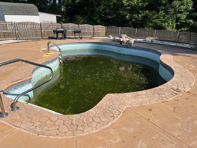 Before: worn or failed vinyl liner, Freeform pool with stamped concrete deck &mdash; new vinyl liner